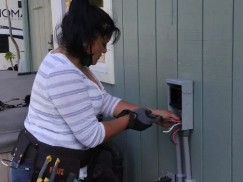 Licensed electrician wiring an exterior subpanel in Mauston