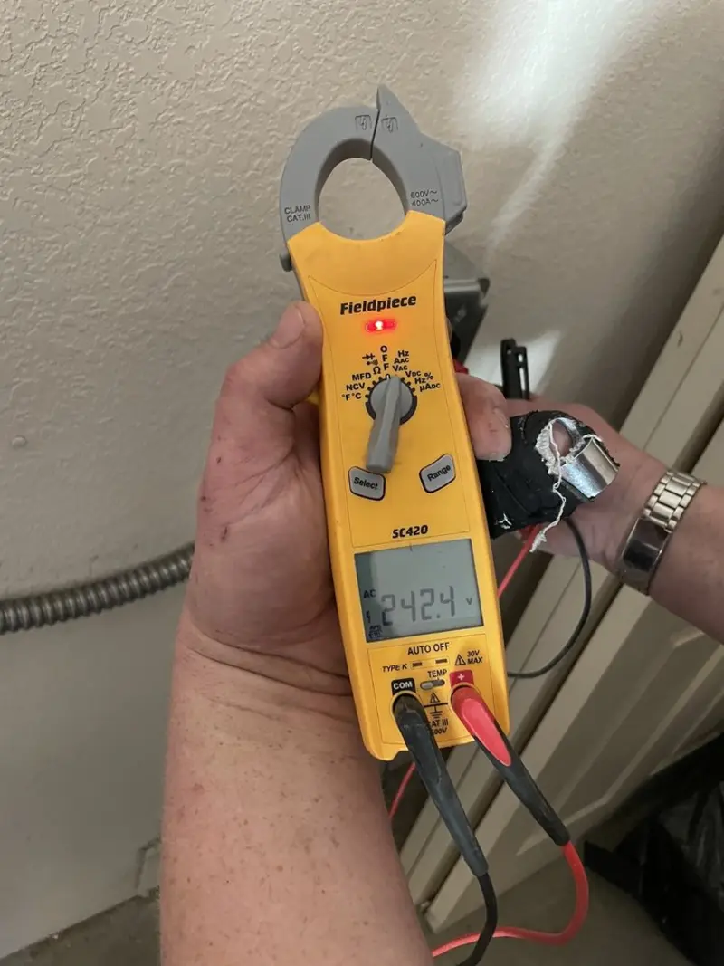 Voltage testing with clamp meter during Electrical Installation Services in Mauston